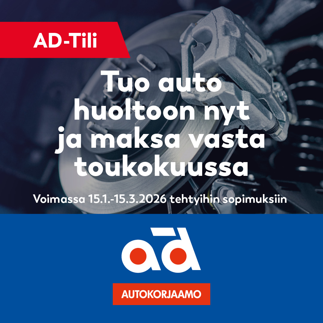 man and woman laughing while sitting in front of laptops